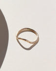 Plunge ring laid on a white plate in the sunlight