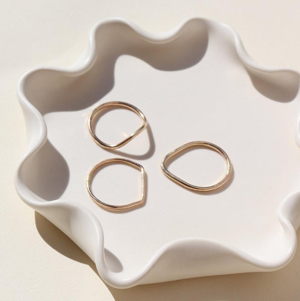 14k gold fill shaped rings on a light dish