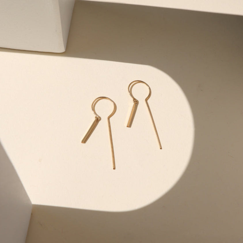 Token Jewelry’s Raya Keyhole Threaders — high-shine, handcrafted threader earrings in 14k gold fill or sterling silver with playful movement.