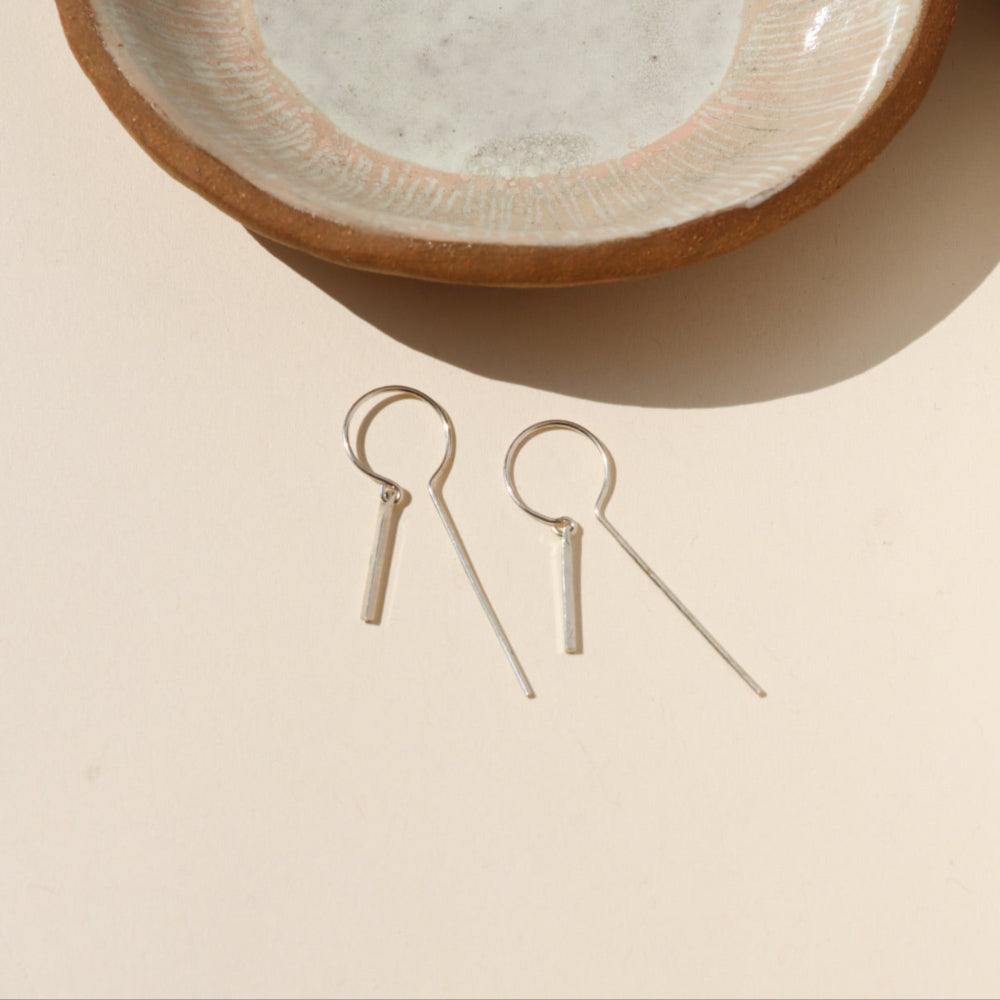 Token Jewelry’s Raya Keyhole Threaders — high-shine, handcrafted threader earrings in 14k gold fill or sterling silver with playful movement.