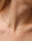 Remy chain necklace in 14k gold fill featuring delicate beaded chain links, worn on a model as a minimalist everyday layering necklace.