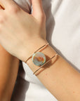 Model wearing the siren cuff. It features a Terra Agate Gemstone wire wrapped to a 14k gold fill wide cuff. 