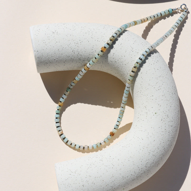 amazonite beaded necklace on a light dish