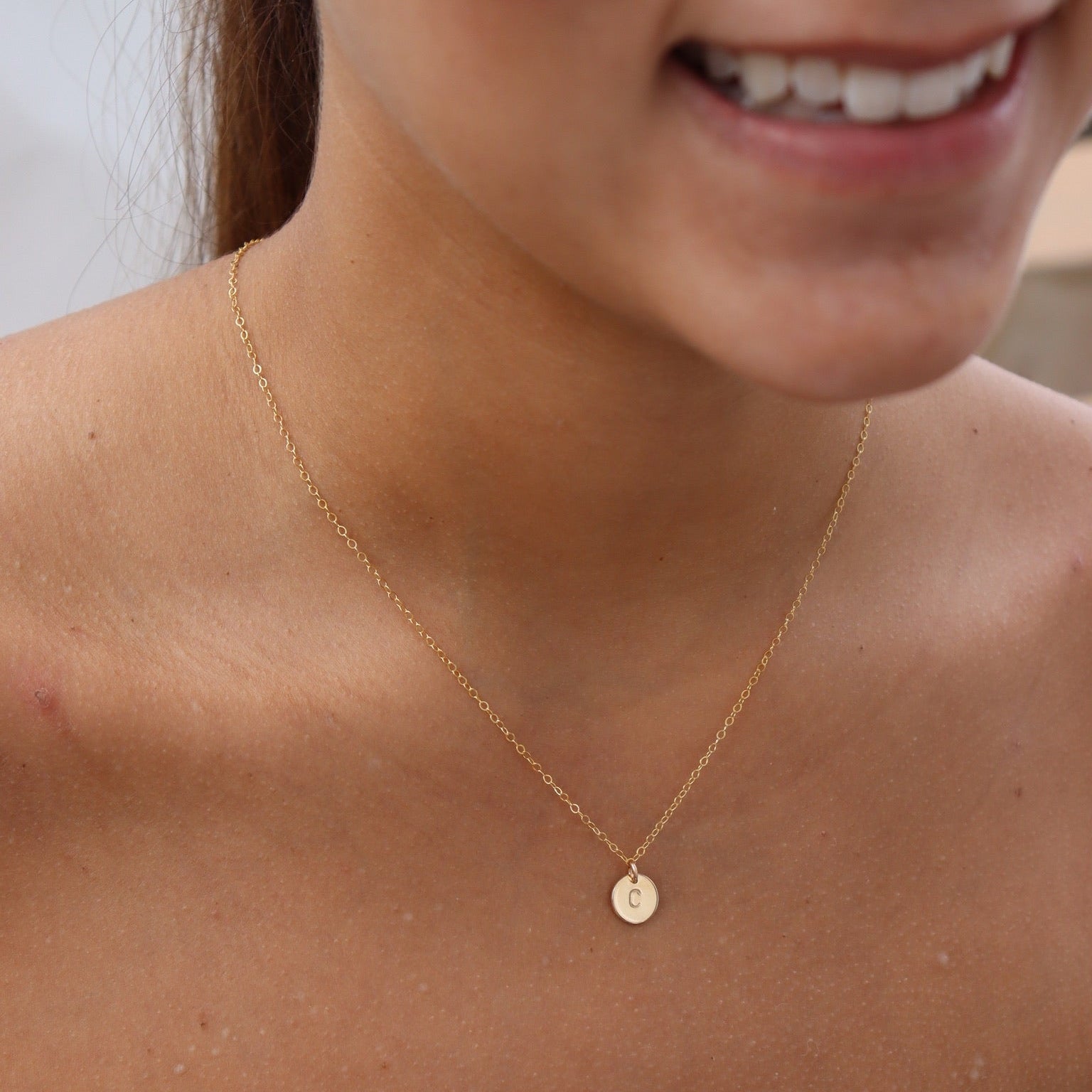 model wearing 14k gold fill dainty chain necklace with hand stamped circle charm