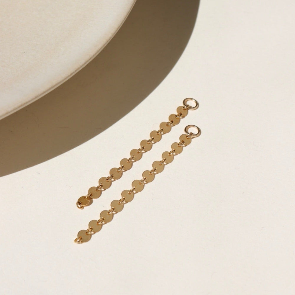 14k gold fill connectors featuring a long circle chain, dropped from a 4mm jump ring, displayed on a cream back drop in the sunlight 