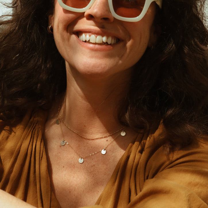 model wearing delicate figaro chain necklace with delicate chan necklace with round charms
