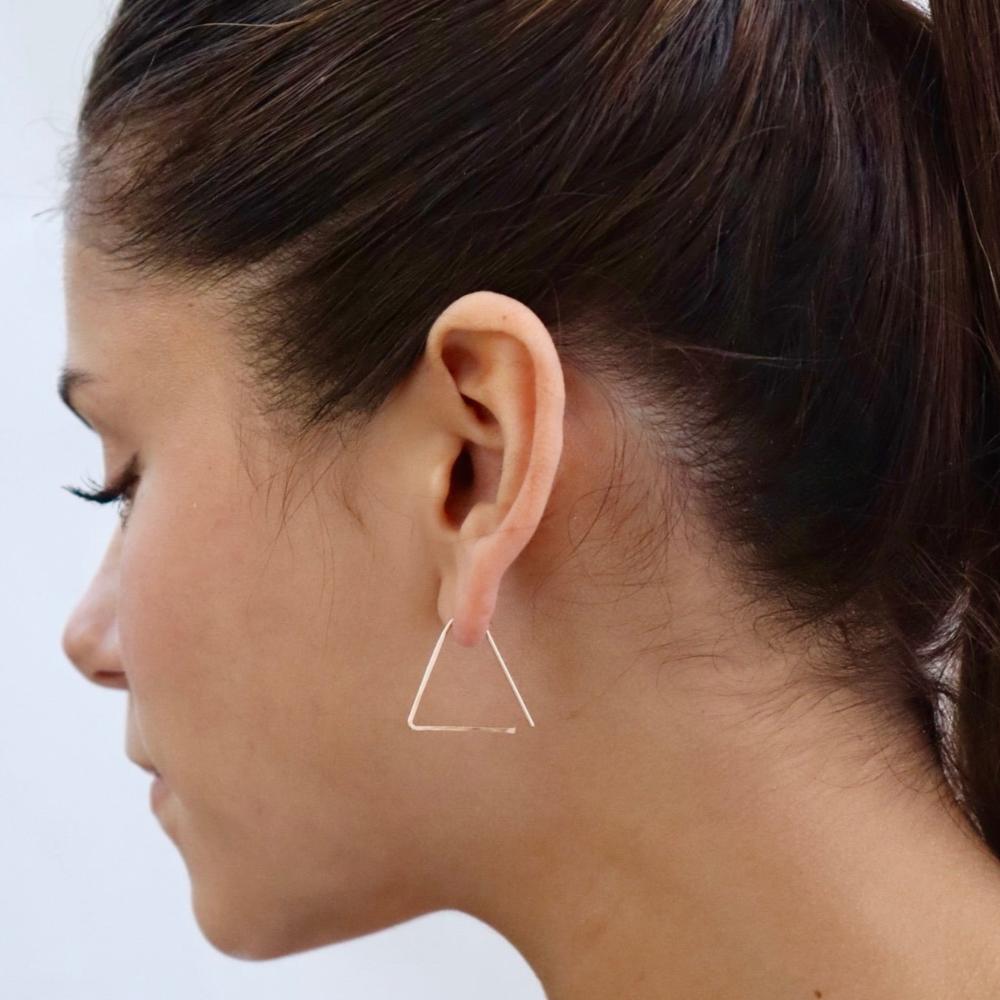model wearing 14k gold fill hammered triangle earrings 