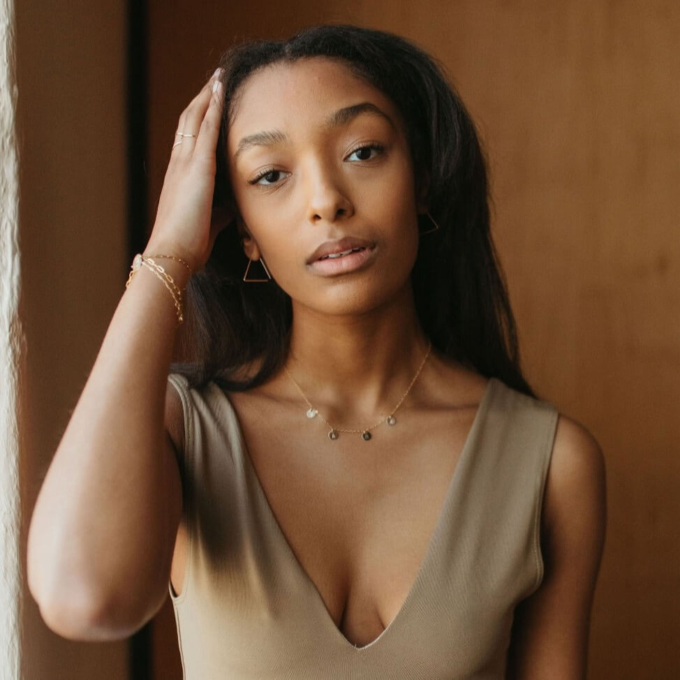 model wearing 14k gold fill hammered triangle earrings with delicate chain necklace with round charms