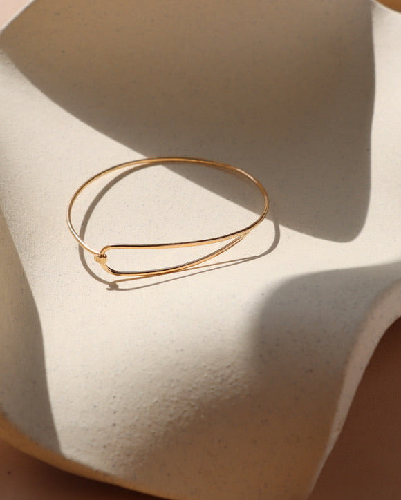 14k gold fill wire bracelet on a light dish