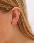 14k gold filled sunrise studs on a model.