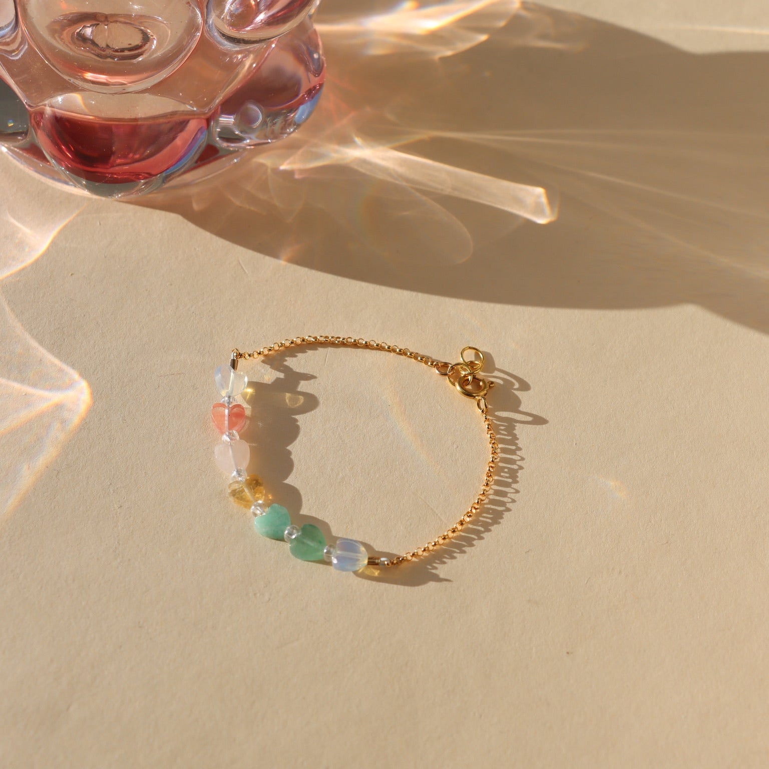 multicolored heart beaded bracelet with 14k gold fill chain in the sunlight
