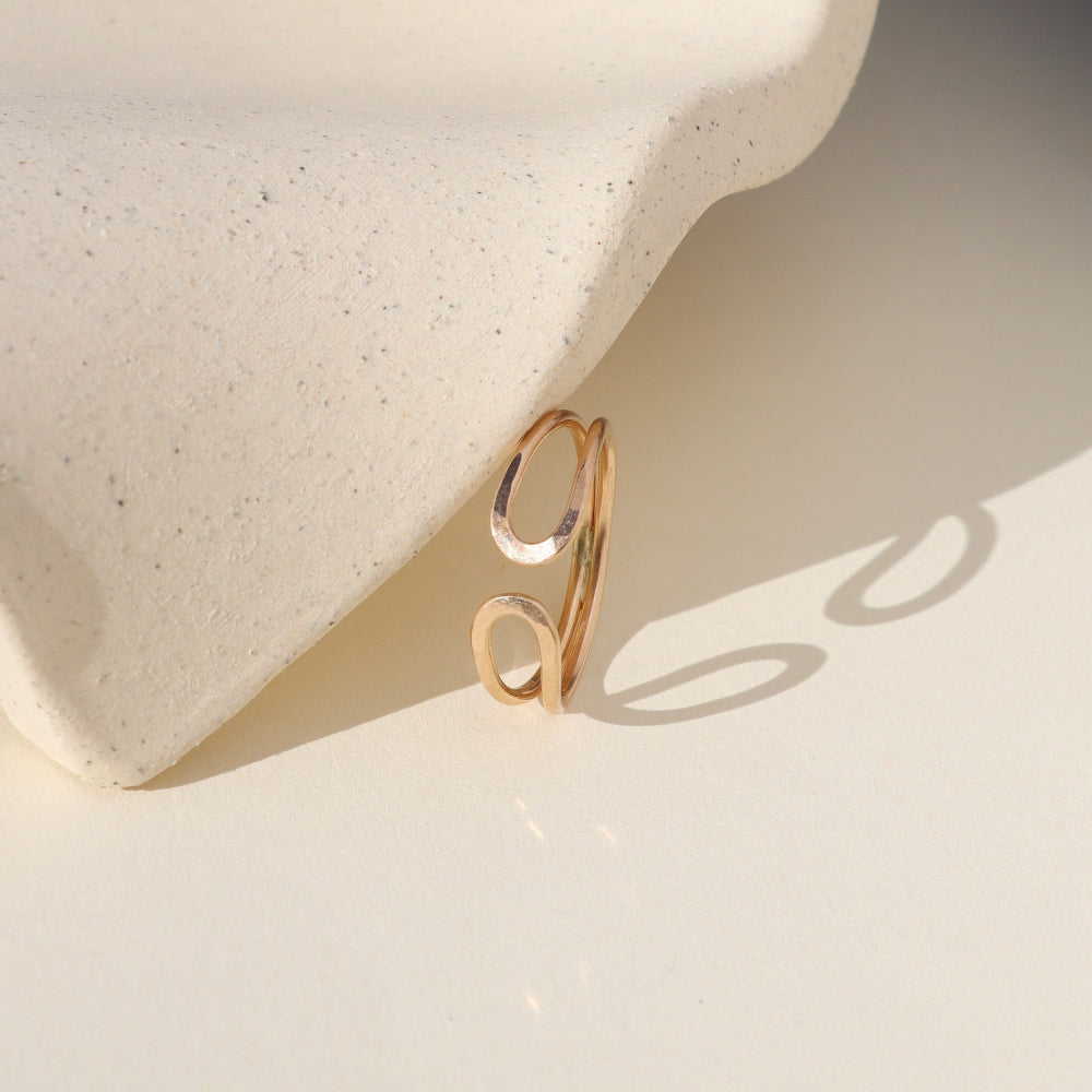 14k gold fill hammered sculptural ring by a light dish
