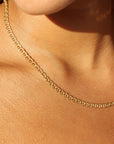 The Marina Chain by Token Jewelry, a modern classic with interlocking oval-shaped links, photographed on a model