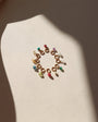 circle of tiny birthstone gemstones on jump rings in the sunlight