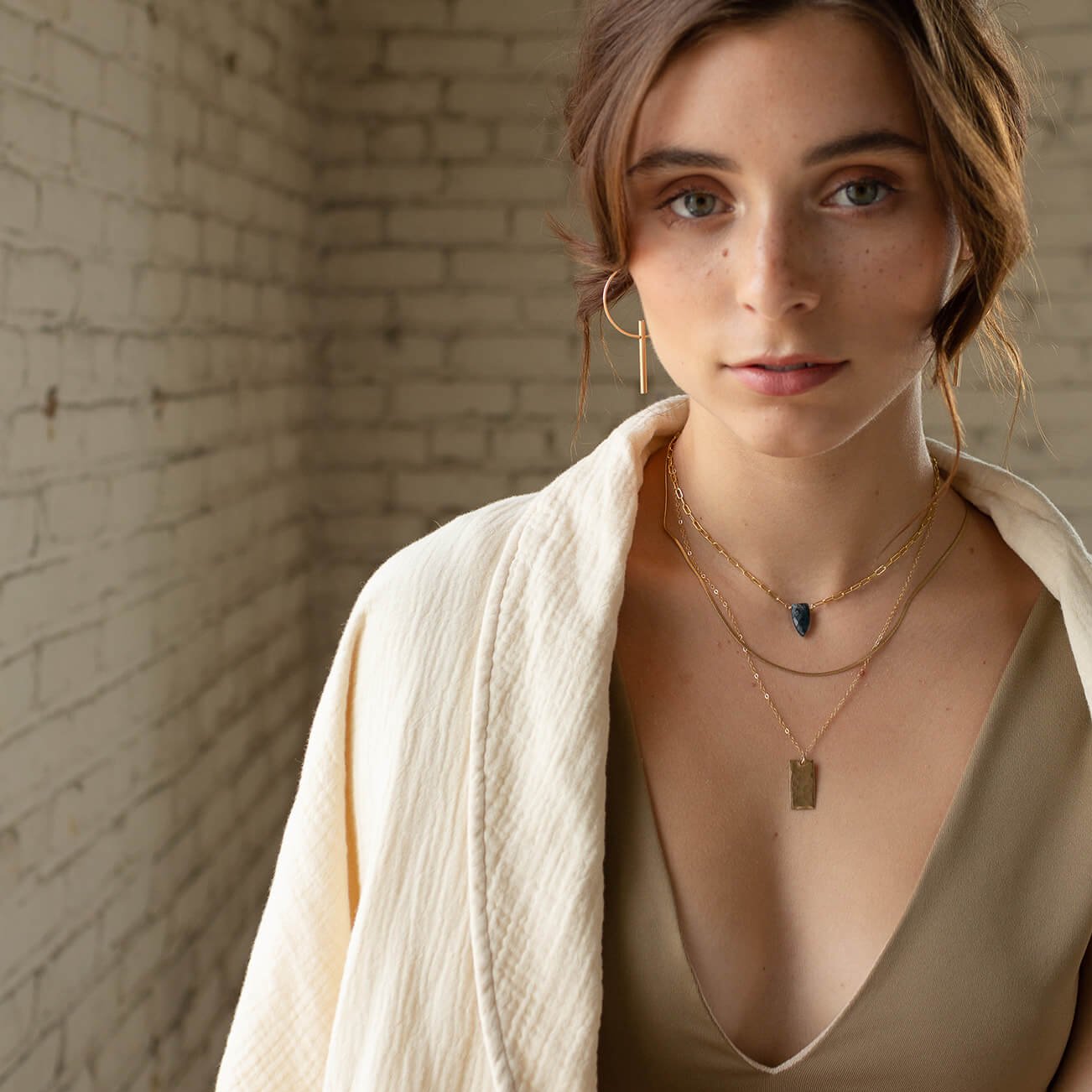 Model wearing 14k gold fill Tunnel Hoops - Token Jewelry - jewelry store near me - Eau Claire jewelry store