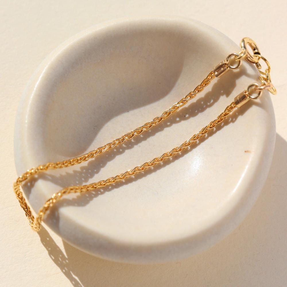 Westly bracelet by Token Jewelry photographed on a dish.