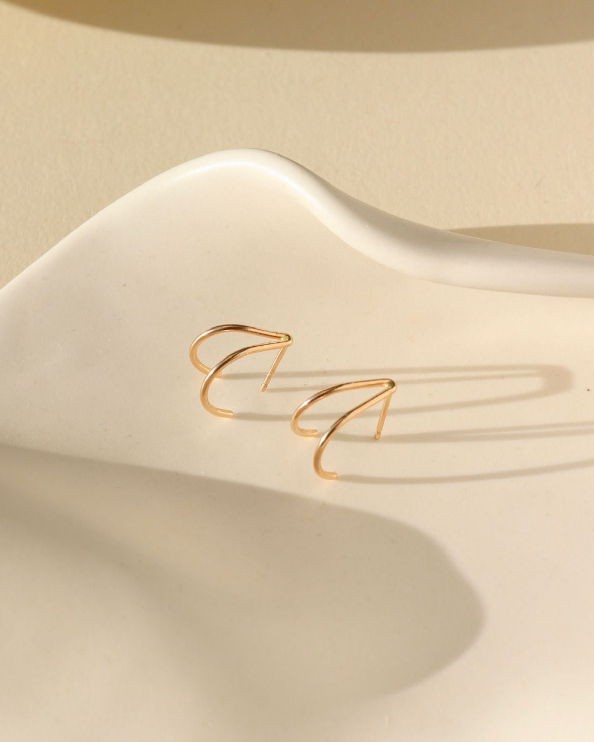 14k gold fill stud earrings on a light dish