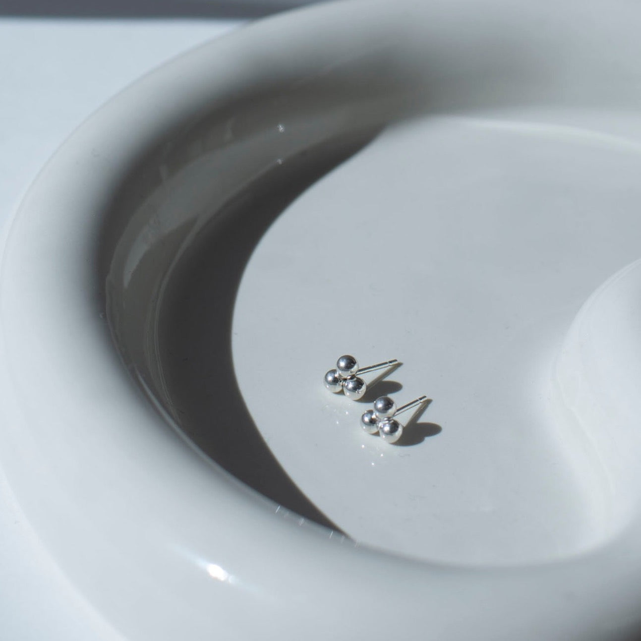 925 sterling silver element studs placed on a white plate