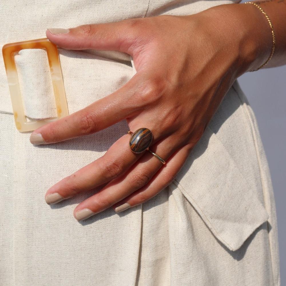 The Woodland Ring by Token Jewelry features a large striped Tiger Eye gemstone on a simple 14k gold fill band. 