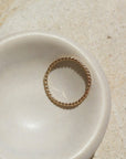 14k gold fill Spiral Ring laid in a white ring dish. This ring features a simple spiral band making it perfect for stacking.