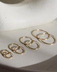 14k gold fill Goldie hoops laid on a white plate. 