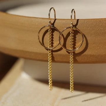 signature earring - hand hammered circle with 2" chain both hanging together from French hooks - 14 gold fill or sterling silver - locally handmade in our Eau Claire, WI studio - Token Jewelry  Edit alt text