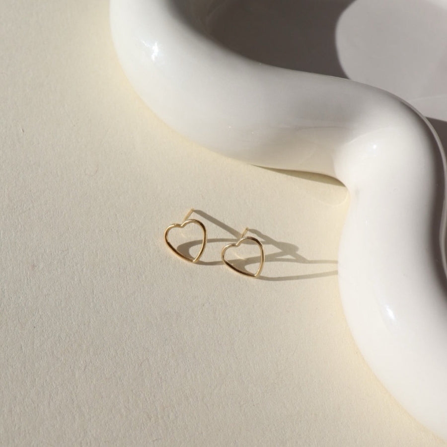 gold fill open heart wire stud earrings on a sunlit tabletop