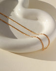 14k gold fill Capri Chain laid on a white plate. Handmade in Eau Claire Wisconsin.