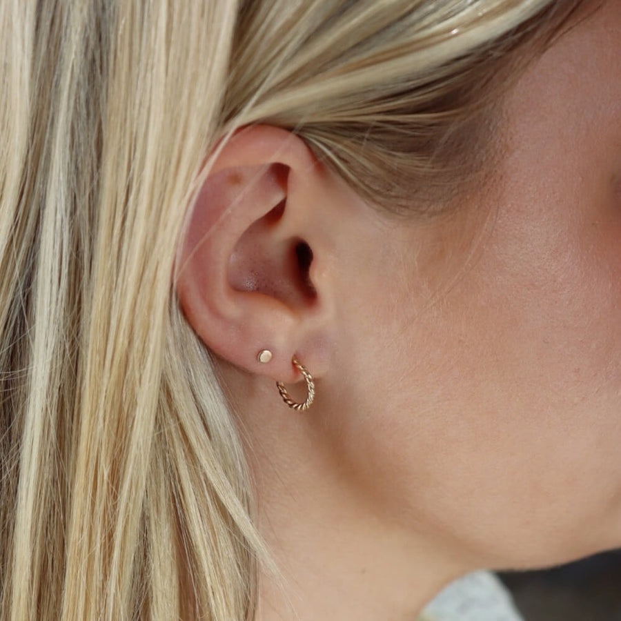 Model wearing 14k gold fill spiral twist wire stud hoops - 14k gold fill or sterling silver - minimal classic everyday look - locally handmade in our Eau Claire, WI studio - Token Jewelry  Edit alt text