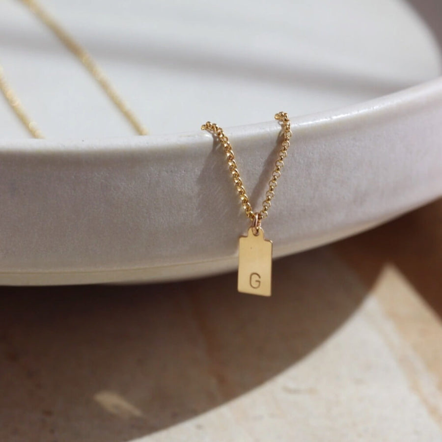14k gold fill Mini Tag Necklace with Monogram. This necklace features the coin necklace chain with a mini tag that has a monogram of your choice. 