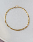 14k gold fill Gigi Anklet placed on a white plate. - Token Jewelry