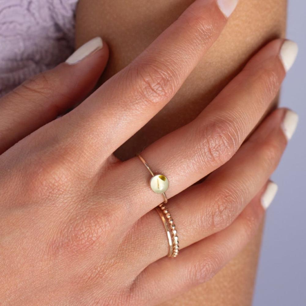 Model wearing Sweet pea ring. This Ring features a smooth band with a prehnite gemstone.