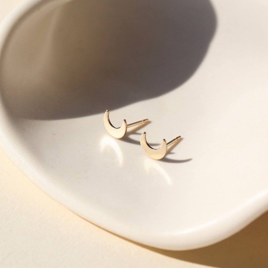 tiny moon studs in 14k gold fill by token jewelry