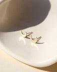 tiny moon studs in 14k gold fill by token jewelry