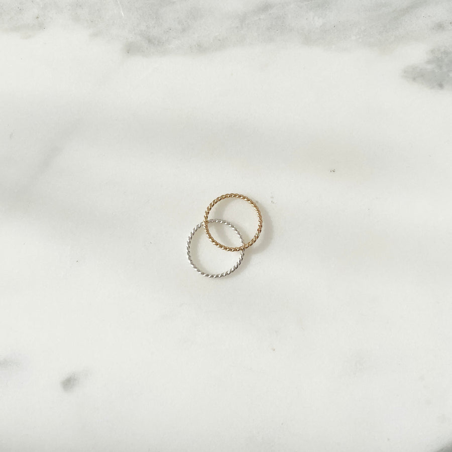 14k gold fill and 925 Sterling silver Spiral Midi Ring placed on a white plate. 